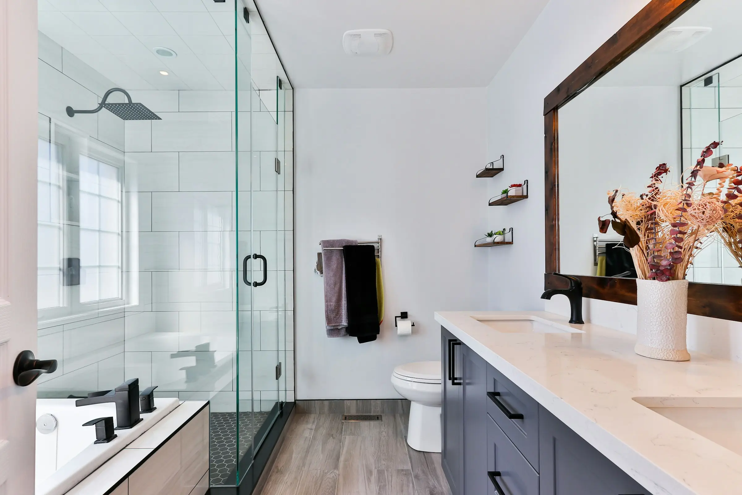 Modernes Badezimmer mit weißen Wandfliesen und Glasdusche